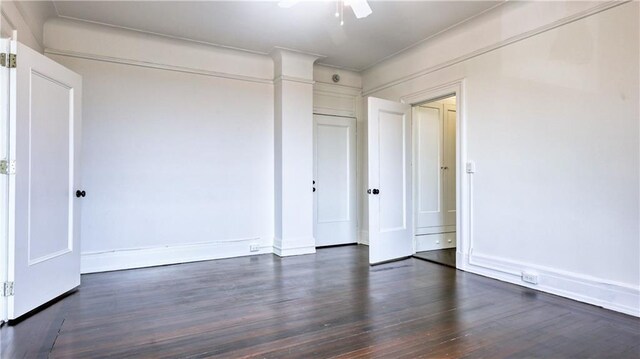 unfurnished bedroom with dark wood-type flooring and ceiling fan