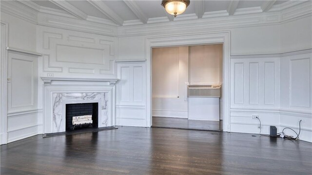 unfurnished living room with a wall mounted AC, a fireplace, dark hardwood / wood-style floors, and beam ceiling