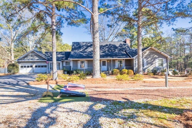 ranch-style house featuring a garage and covered porch