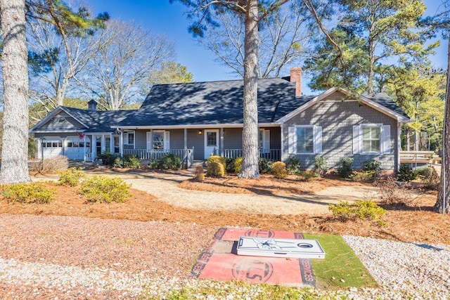 ranch-style house featuring a garage and covered porch