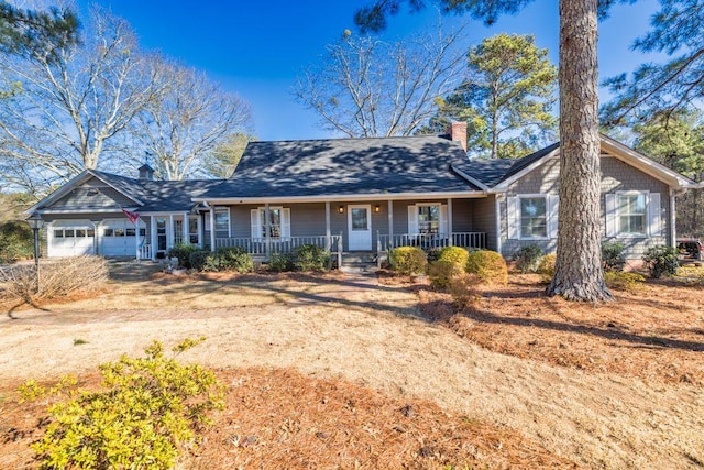 ranch-style home with a porch and a garage