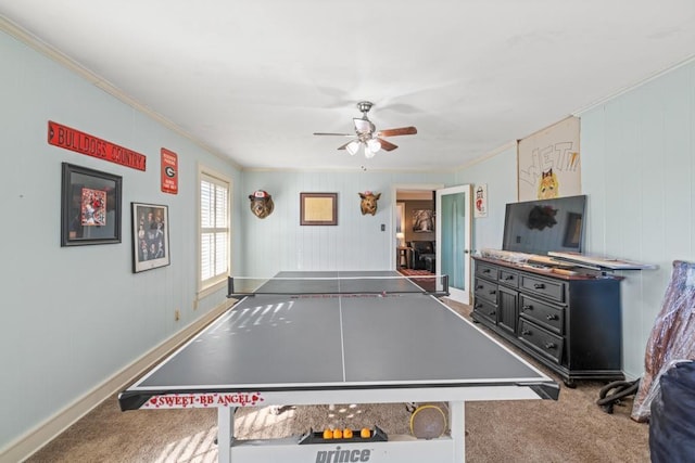 recreation room with ornamental molding, ceiling fan, and carpet