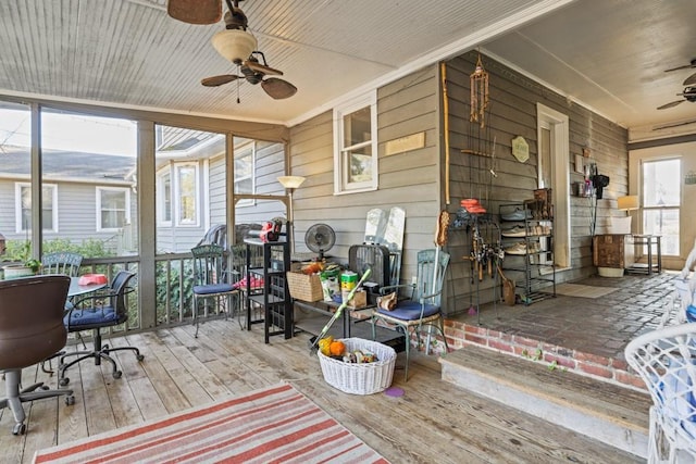 sunroom / solarium featuring ceiling fan