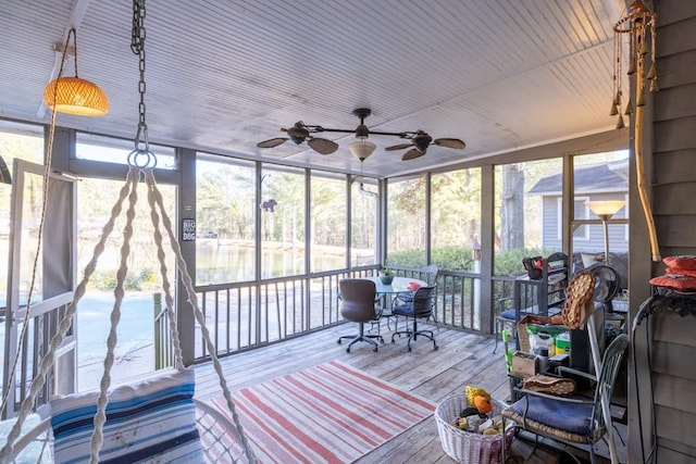 unfurnished sunroom with ceiling fan