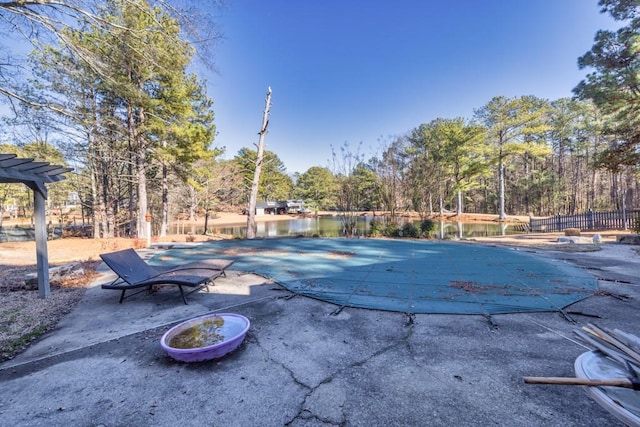 view of swimming pool with a water view, a pergola, and a patio