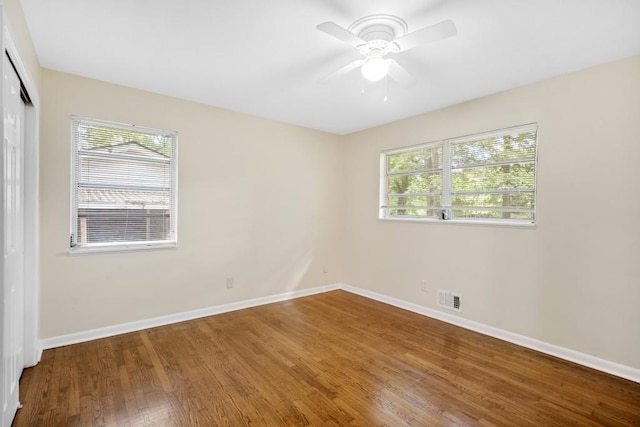 4400 Hickory Wood Ln, Atlanta, GA 30360 - empty room with plenty of natural light, wood finished floors, baseboards, and ceiling fan