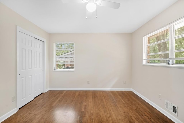 4400 Hickory Wood Ln, Atlanta, GA 30360 - unfurnished bedroom with wood finished floors, baseboards, a closet, and ceiling fan