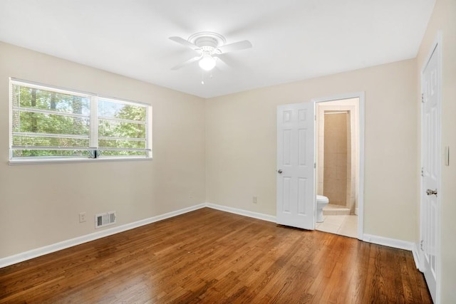 4400 Hickory Wood Ln, Atlanta, GA 30360 - unfurnished bedroom with wood finished floors, baseboards, ensuite bathroom, and ceiling fan