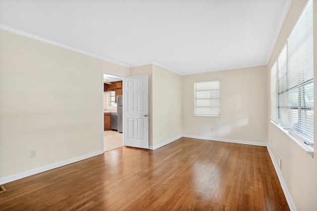 4400 Hickory Wood Ln, Atlanta, GA 30360 - spare room with wood finished floors, plenty of natural light, baseboards, and ornamental molding
