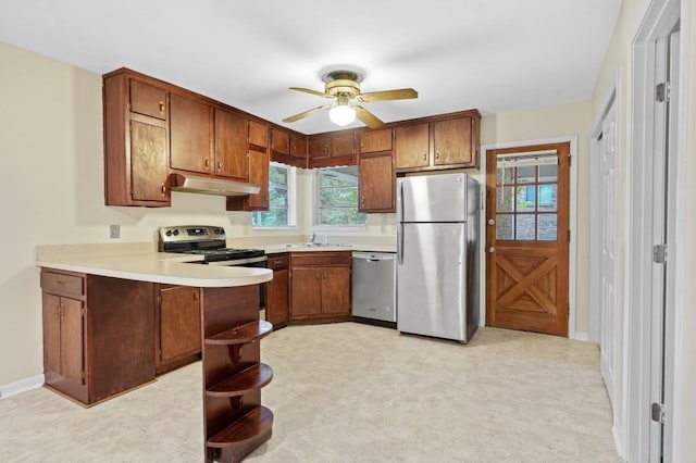 4400 Hickory Wood Ln, Atlanta, GA 30360 - kitchen featuring appliances with stainless steel finishes, under cabinet range hood, a peninsula, a sink, and light countertops