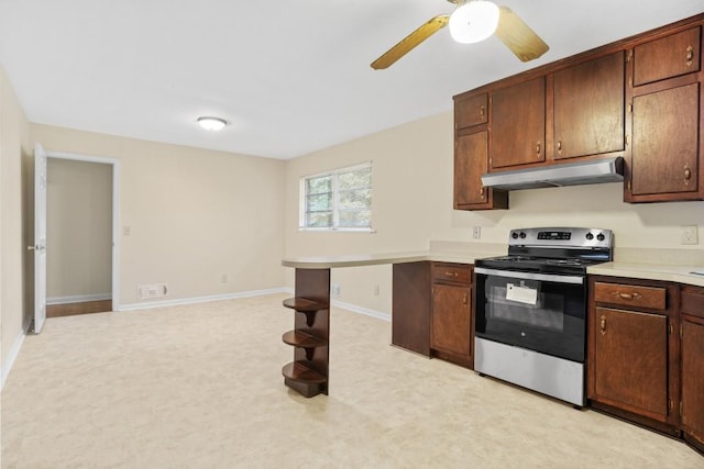 4400 Hickory Wood Ln, Atlanta, GA 30360 - kitchen featuring stainless steel range with electric cooktop, under cabinet range hood, light countertops, ceiling fan, and baseboards