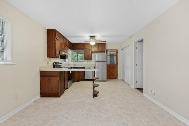 4400 Hickory Wood Ln, Atlanta, GA 30360 - kitchen with stainless steel appliances, light countertops, a ceiling fan, baseboards, and under cabinet range hood