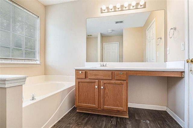 bathroom featuring a tub to relax in, vanity, and hardwood / wood-style flooring