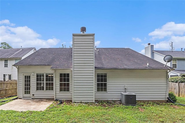 back of house featuring a patio, a yard, and central AC unit