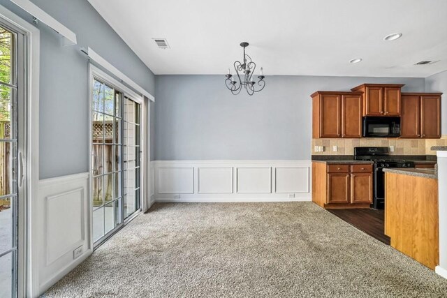 2872 Cross Creek Ct, Cumming, GA 30040 - kitchen with black appliances, a wealth of natural light, a notable chandelier, and visible vents