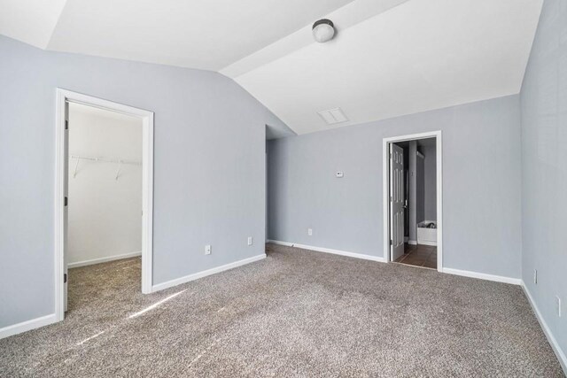 2872 Cross Creek Ct, Cumming, GA 30040 - unfurnished bedroom with carpet flooring, vaulted ceiling, baseboards, a spacious closet, and a closet