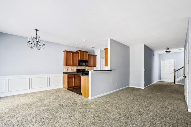 2872 Cross Creek Ct, Cumming, GA 30040 - kitchen with brown cabinetry, black appliances, decorative backsplash, a chandelier, and dark carpet
