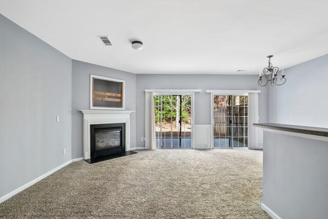 2872 Cross Creek Ct, Cumming, GA 30040 - unfurnished living room with a fireplace with flush hearth, visible vents, carpet flooring, and an inviting chandelier