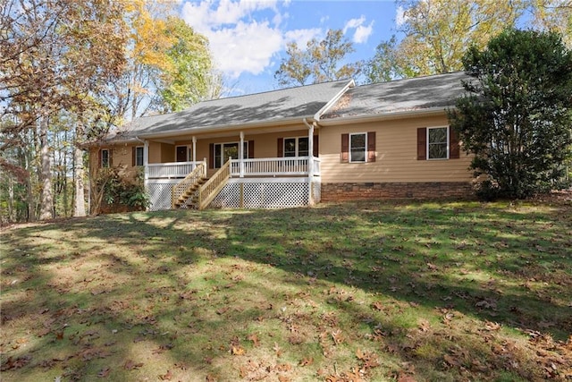 single story home with covered porch, a front lawn, and stairway