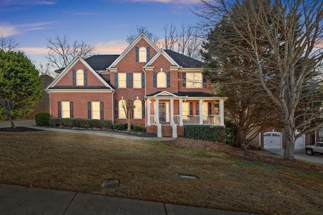 view of front facade with a yard and covered porch