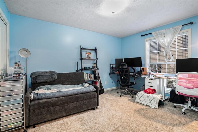 carpeted office featuring a textured ceiling