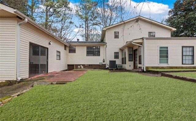 rear view of house featuring a yard, a patio area, crawl space, and cooling unit