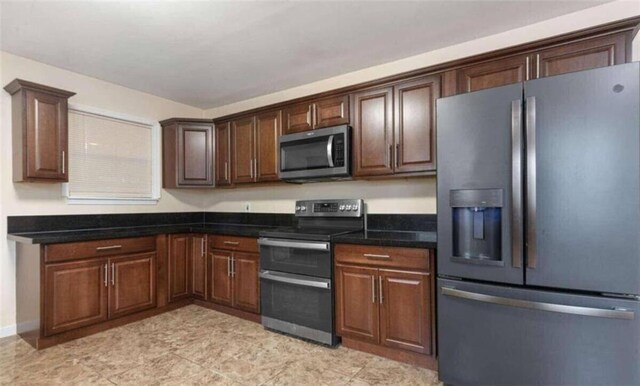 kitchen with dark brown cabinets and appliances with stainless steel finishes