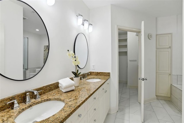 2828 Peachtree Rd NW Unit 1502, Atlanta, GA 30305 - full bathroom with marble look tiles, double vanity, and a spacious closet