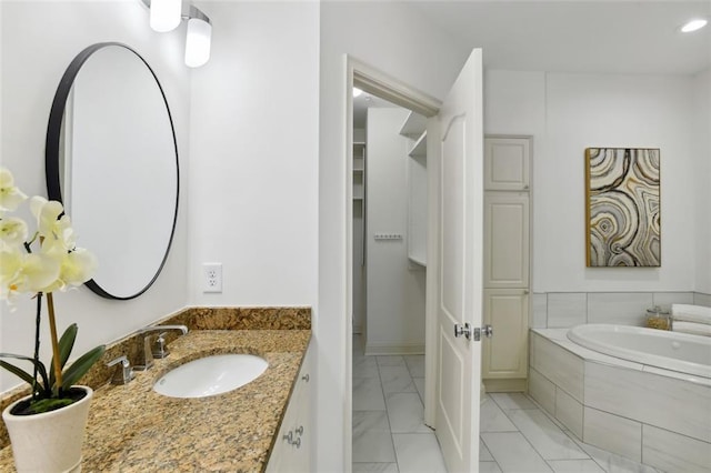2828 Peachtree Rd NW Unit 1502, Atlanta, GA 30305 - full bathroom featuring a garden tub, marble finish floors, and vanity
