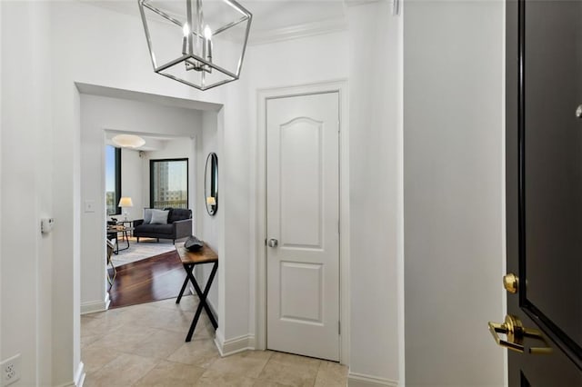 2828 Peachtree Rd NW Unit 1502, Atlanta, GA 30305 - hall with light tile patterned floors, a chandelier, and crown molding