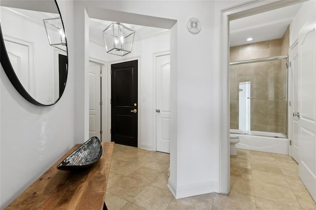 2828 Peachtree Rd NW Unit 1502, Atlanta, GA 30305 - entryway with a chandelier, light tile patterned floors, and crown molding
