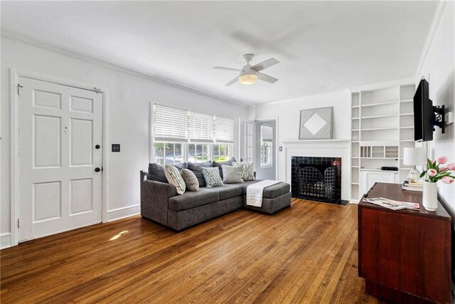 131 Lively St, Norcross, GA 30071 - living area with ceiling fan, ornamental molding, a fireplace, wood finished floors, and baseboards