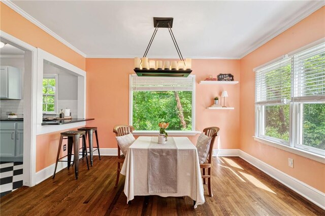 131 Lively St, Norcross, GA 30071 - dining space featuring dark wood finished floors, healthy amount of natural light, crown molding, and baseboards