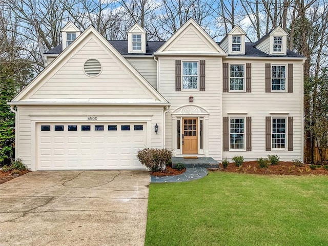 colonial-style house with a garage, concrete driveway, and a front yard