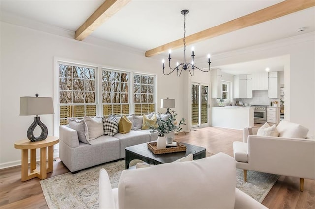 living room featuring a chandelier, light wood-type flooring, beam ceiling, and baseboards