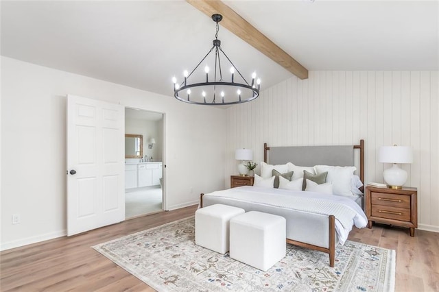 bedroom with light wood-style floors, a sink, vaulted ceiling with beams, and baseboards