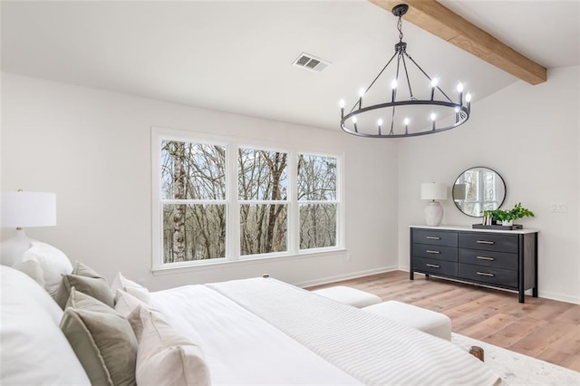 bedroom featuring vaulted ceiling with beams, multiple windows, light wood-type flooring, and visible vents