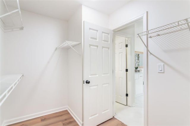 walk in closet featuring light wood-style floors