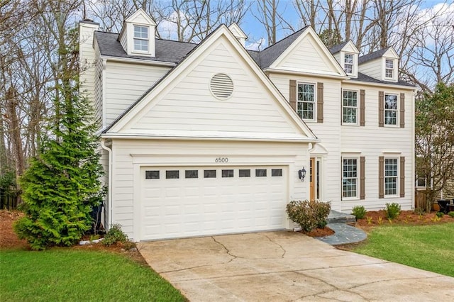 view of front of house with a garage, a front yard, concrete driveway, and a chimney