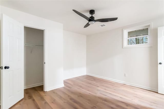 unfurnished bedroom with ceiling fan, visible vents, baseboards, a closet, and light wood-type flooring