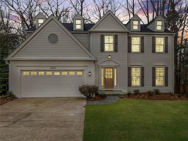 view of front of home featuring a garage, concrete driveway, and a front lawn