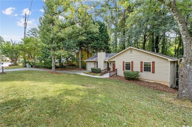 ranch-style home with a garage and a front yard