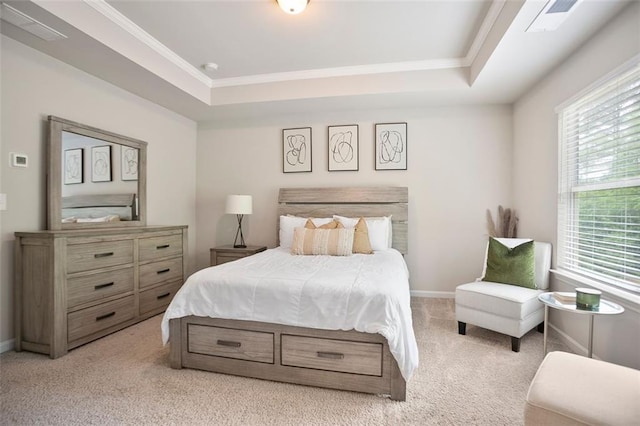 carpeted bedroom featuring a tray ceiling, crown molding, and baseboards