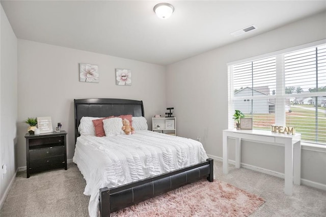 carpeted bedroom with multiple windows and baseboards