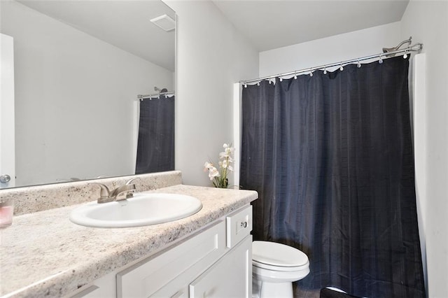 full bathroom with toilet, vanity, and a shower with curtain