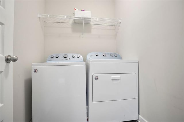 clothes washing area featuring separate washer and dryer