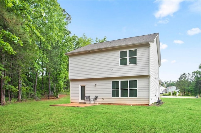back of property featuring a patio and a yard