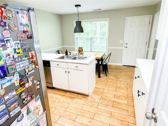 320 Kentshire, Lawrenceville, GA 30044 - kitchen with decorative light fixtures, sink, white cabinets, light hardwood / wood-style floors, and stainless steel appliances