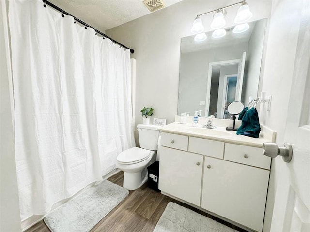 320 Kentshire, Lawrenceville, GA 30044 - bathroom with hardwood / wood-style flooring, a shower with shower curtain, vanity, a textured ceiling, and toilet