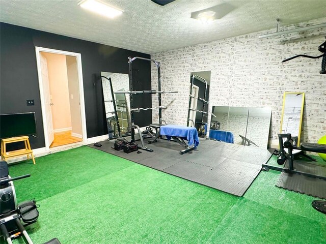 320 Kentshire, Lawrenceville, GA 30044 - workout area with brick wall and a textured ceiling